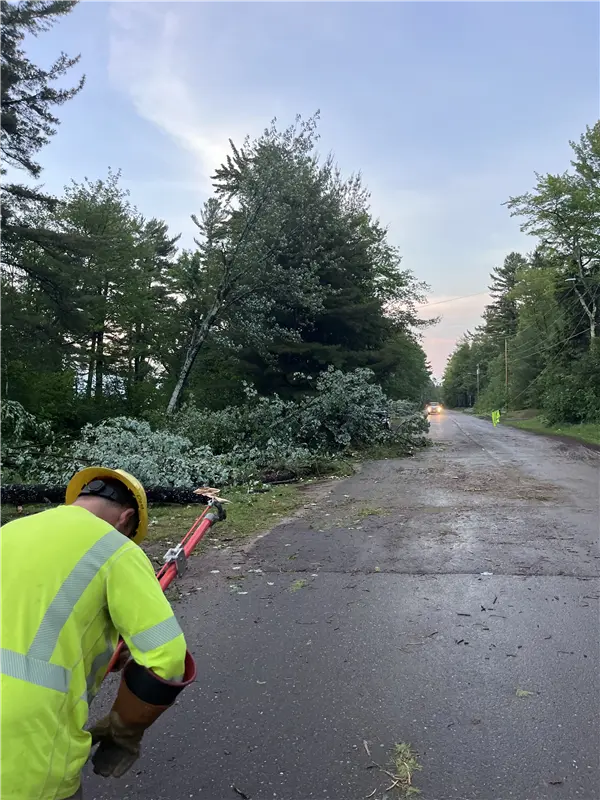 An UPPCO employee evaluates storm damage