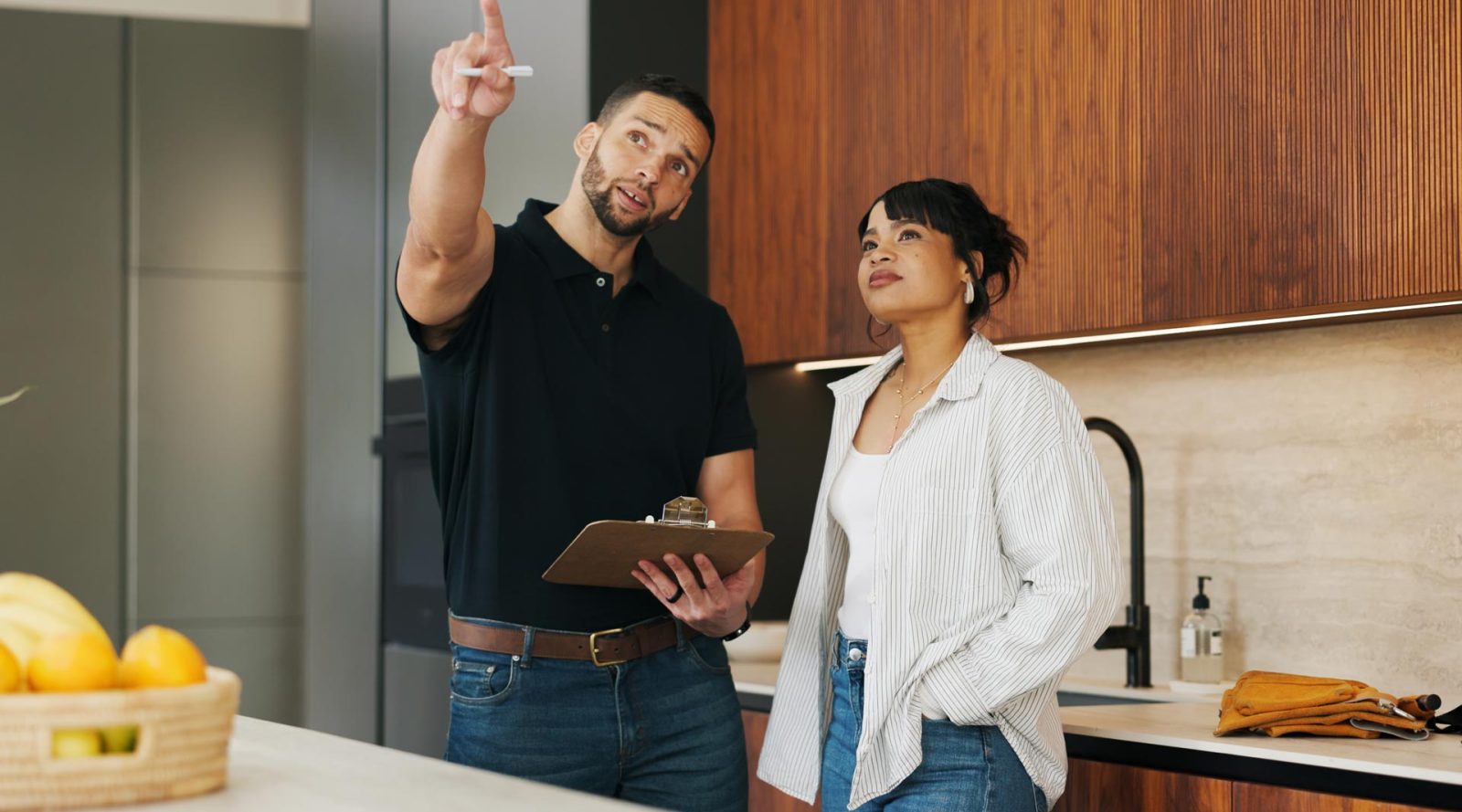 An energy professional meets with an UPPCO customer in their home during a home energy assessment.