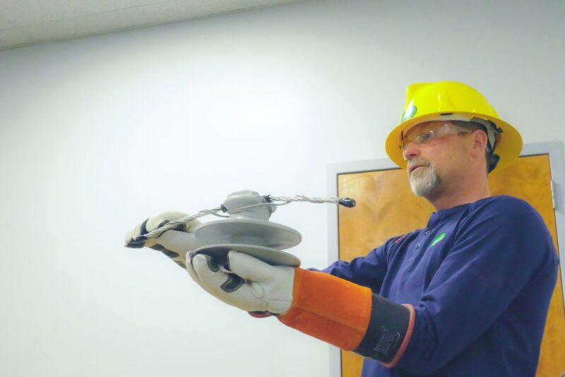 UPPCO representative shows off tools at a classroom presentation