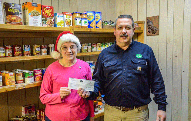 Scott Roehl, UPPCO Operations Supervisor, presents a check to Jo Callovi, president of the Sts. Cecilia and Agnes Conference, Society of St. Vincent de Paul.