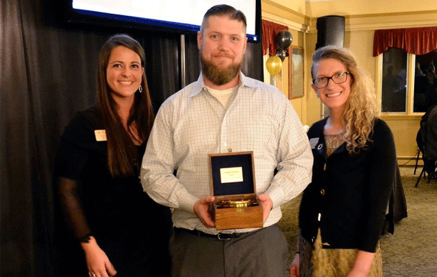 UPPCO’S Katie Kern presents Business of the Year award to Brian Richards, Brewer for local microbrewery in Ishpeming MI, Cognition.