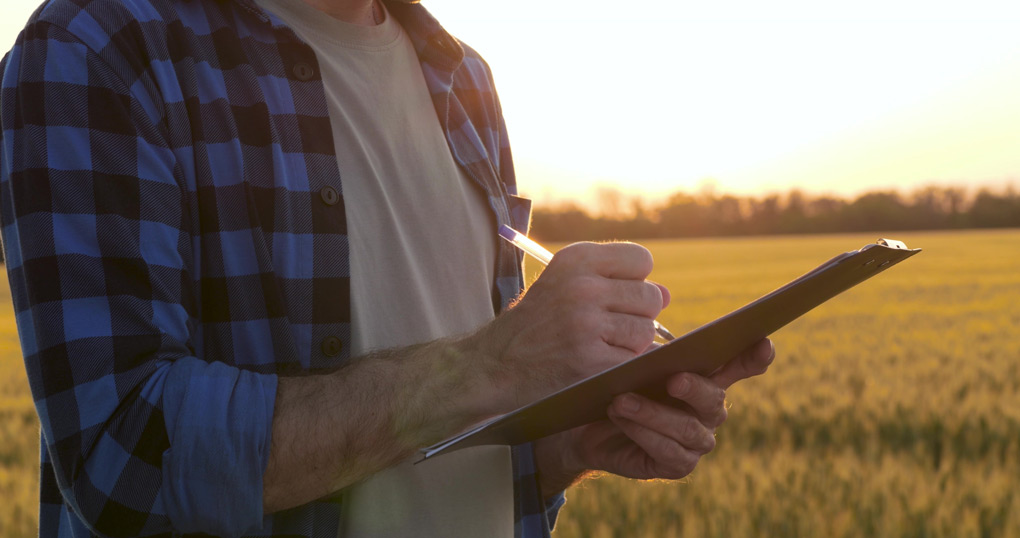 A man holding a clipboard and pen