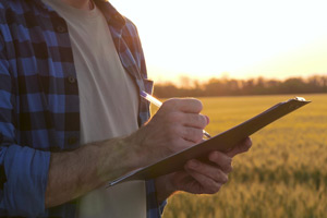 A man holding a clipboard and a pen