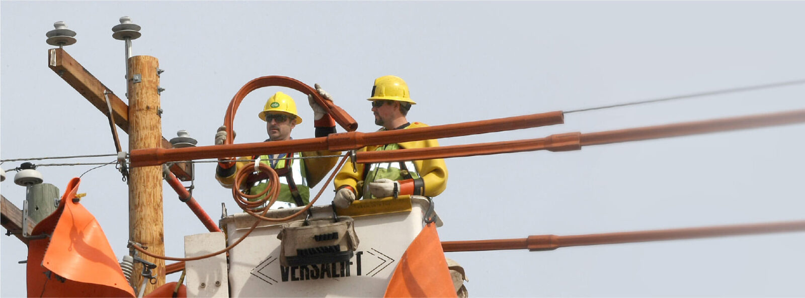 crew replacing guards on power pole